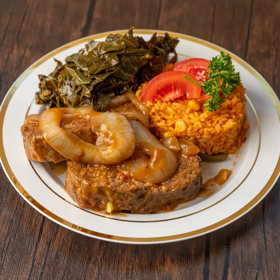 Meatloaf with gravy and onions, collard greens, and Spanish rice with tomatoes and parsley.